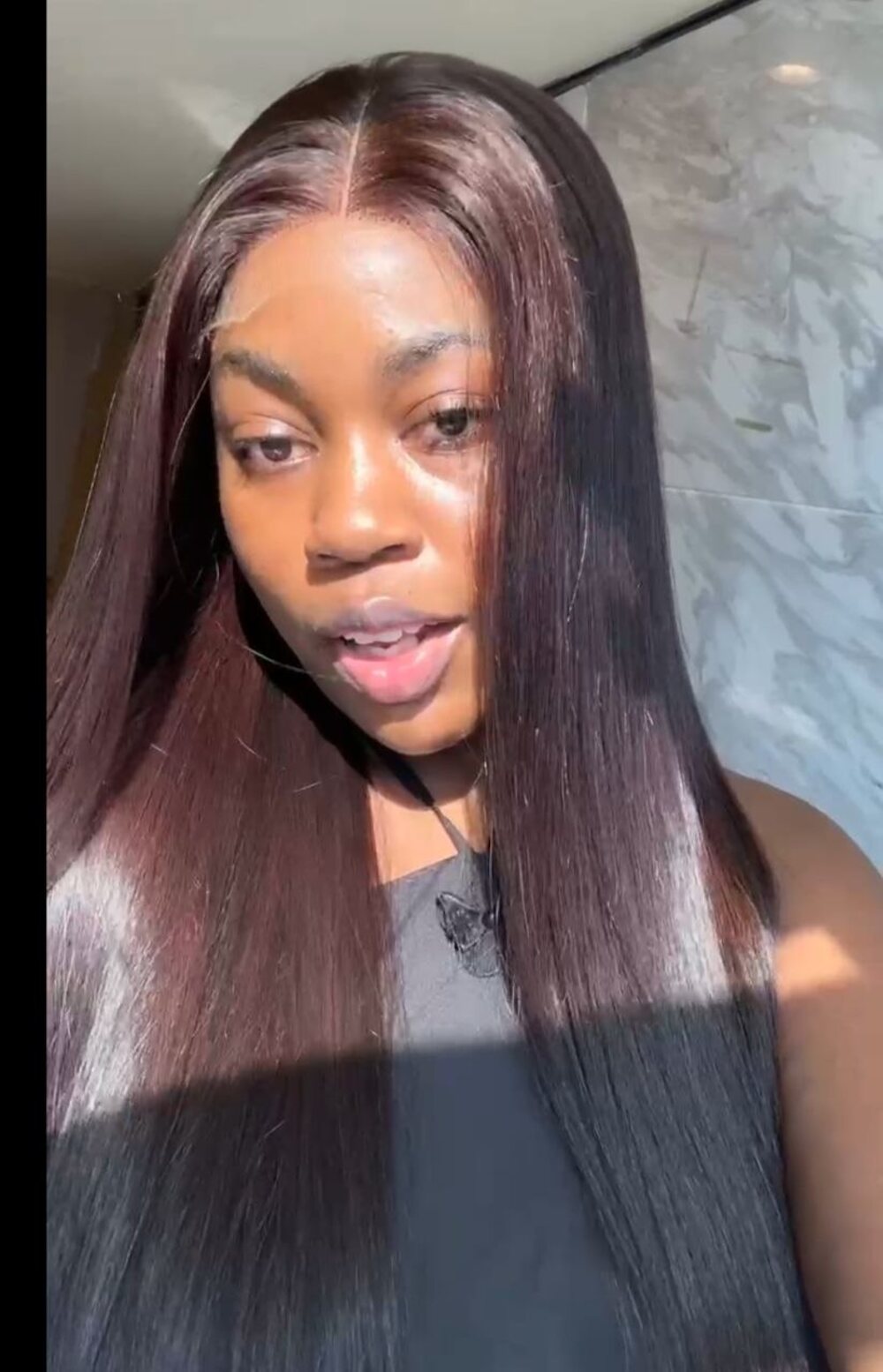 Tasha, founder of Swt. Hair, wearing the plum straight unit